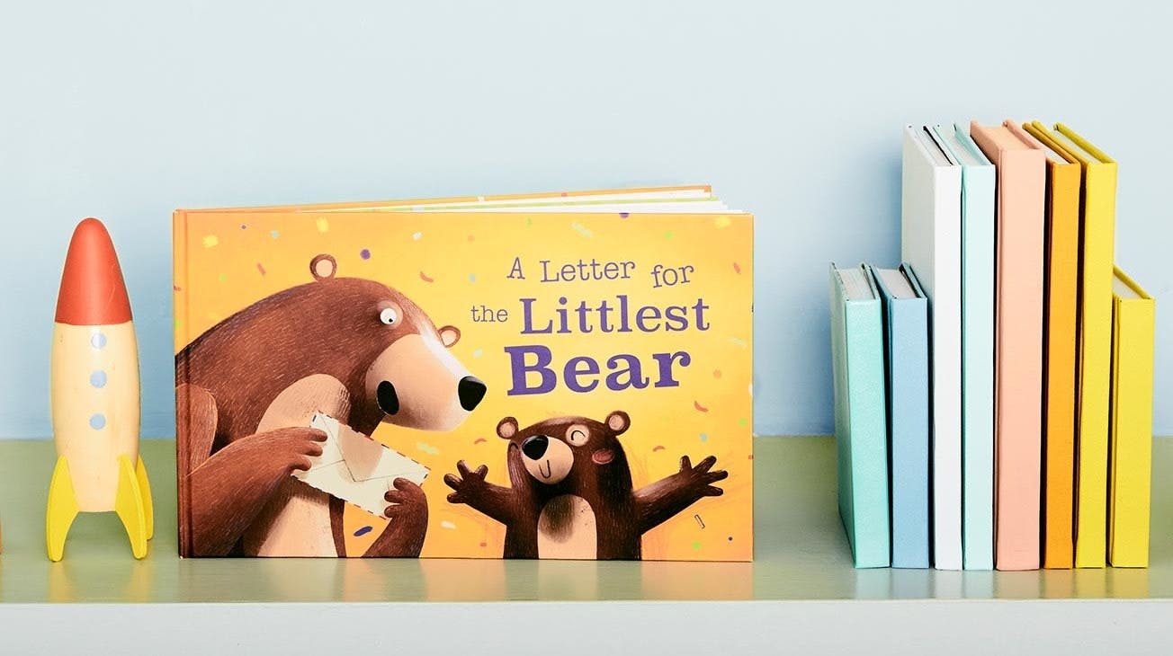 The Littlest Bear book sitting on the child's bookshelf